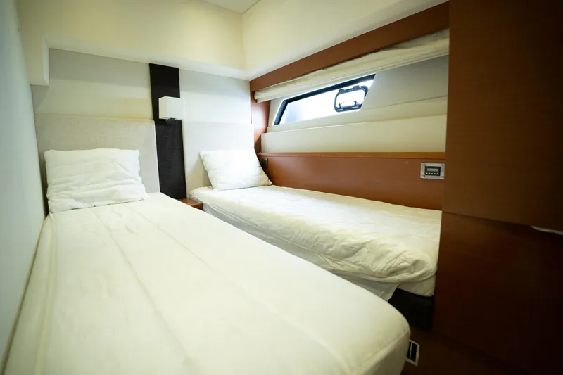  Yacht Photos Pics Twin cabin beds in a 2014 Prestige 550 yacht, featuring modern design and cozy ambiance.
