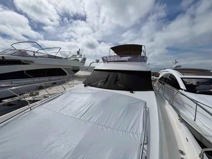  Yacht Photos Pics 2014 Prestige 550 yacht docked under cloudy sky.