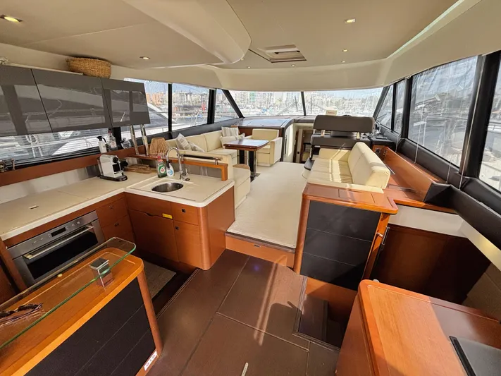 Yacht Photos Pics Luxurious interior of a 2014 Prestige 550 yacht with modern kitchen and seating area.