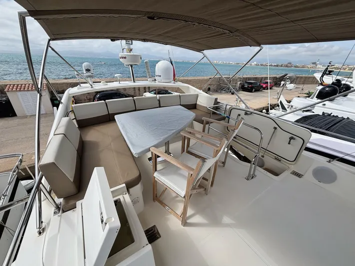  Yacht Photos Pics Flybridge of 2014 Prestige 550 yacht with seating, table, and ocean view.