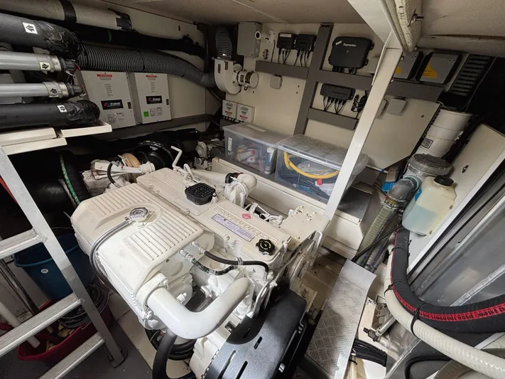  Yacht Photos Pics Engine room of a 2014 Prestige 550 yacht, showcasing mechanical components and storage.