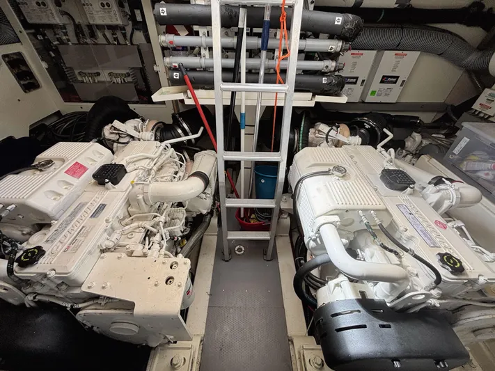  Yacht Photos Pics Engine room of a 2014 Prestige 550 yacht with dual engines and central ladder.