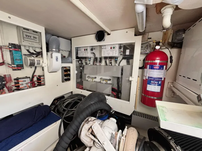  Yacht Photos Pics Engine room of a 2014 Prestige 550 yacht with control panels and fire extinguisher.