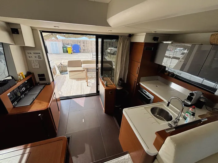  Yacht Photos Pics Interior of a 2014 Prestige 550 yacht, featuring a modern kitchen and seating area.