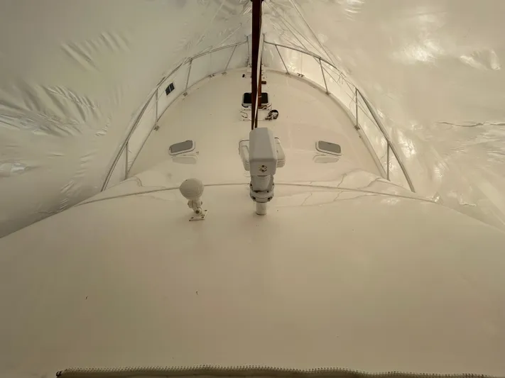  Yacht Photos Pics 2007 Luhrs 36 Convertible yacht under protective cover, showcasing deck and equipment.