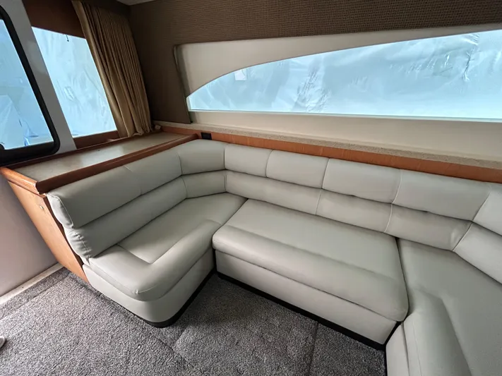  Yacht Photos Pics 2007 Luhrs 36 Convertible yacht interior with plush L-shaped seating and large window.