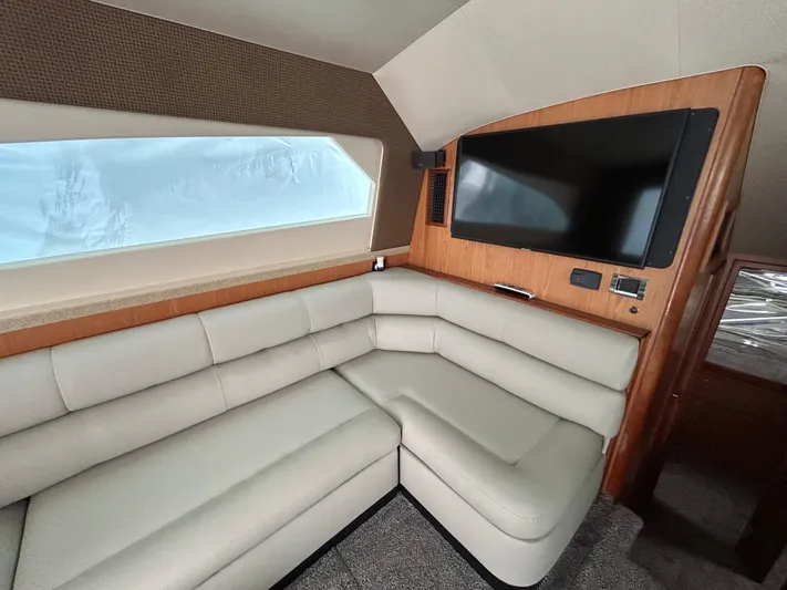  Yacht Photos Pics Interior of 2007 Luhrs 36 Convertible yacht with beige leather seating and mounted TV.