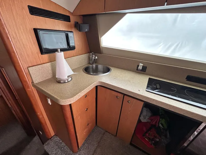  Yacht Photos Pics 2007 Luhrs 36 Convertible yacht kitchen with sink, microwave, and stovetop.