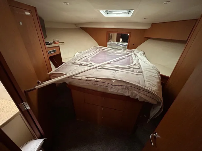  Yacht Photos Pics Interior cabin of 2007 Luhrs 36 Convertible boat with bed and wooden cabinetry.