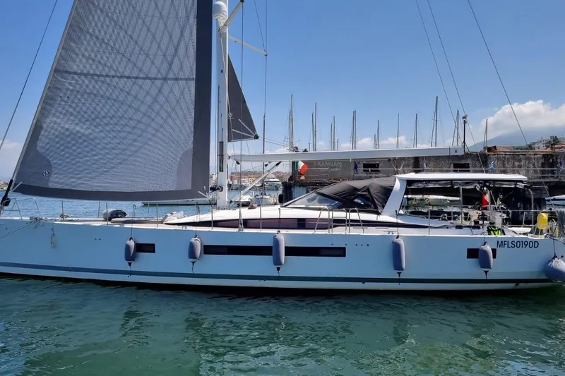  Yacht Photos Pics 2023 Jeanneau 65 Yacht docked in a marina, showcasing sleek design and modern sails.