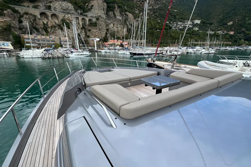  Yacht Photos Pics Luxurious 2024 Pershing 8X yacht with elegant deck seating in scenic marina.