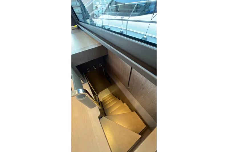  Yacht Photos Pics Staircase inside 2024 Pershing 8X yacht, featuring sleek wooden design and modern railing.