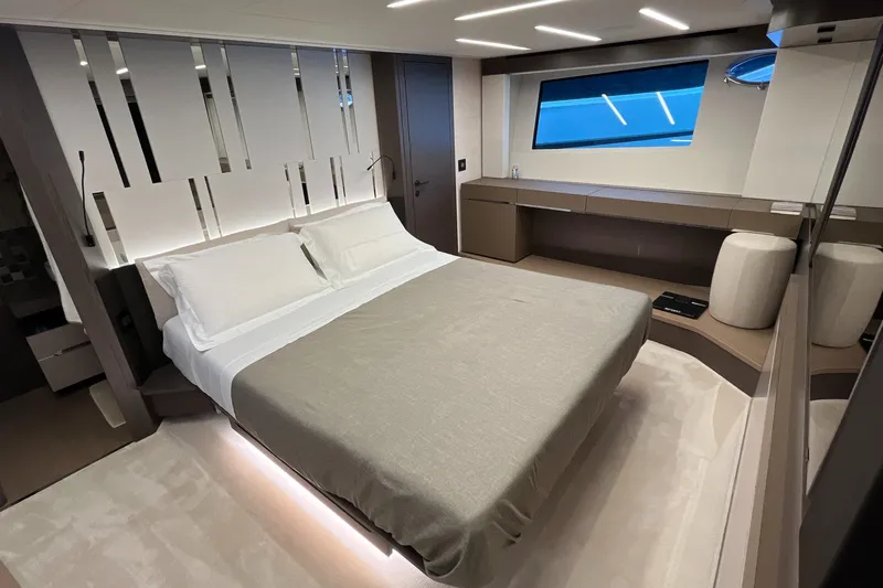 Yacht Photos Pics Luxurious bedroom interior of 2024 Pershing 8X yacht with modern design and ambient lighting.