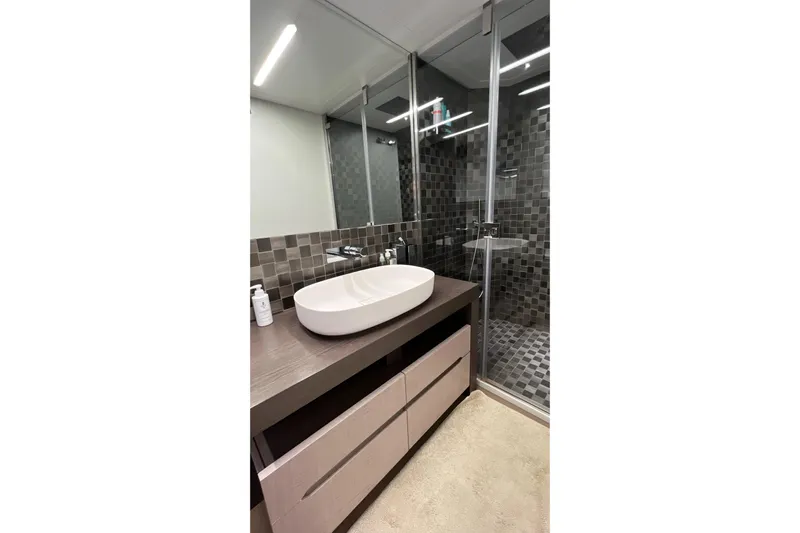 Yacht Photos Pics Luxurious bathroom in 2024 Pershing 8X yacht with modern sink and glass shower.