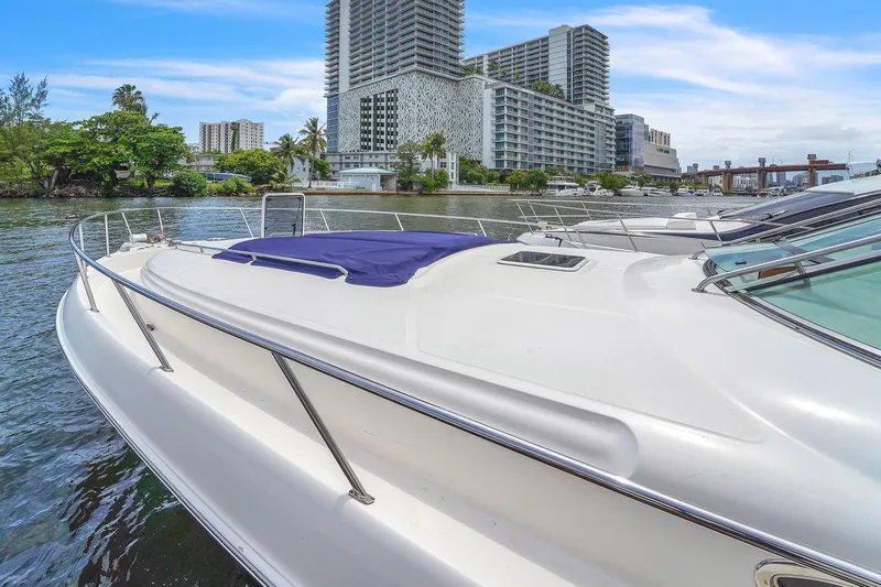  Yacht Photos Pics 2004 Sea Ray 460 Sundancer yacht docked near urban waterfront buildings.