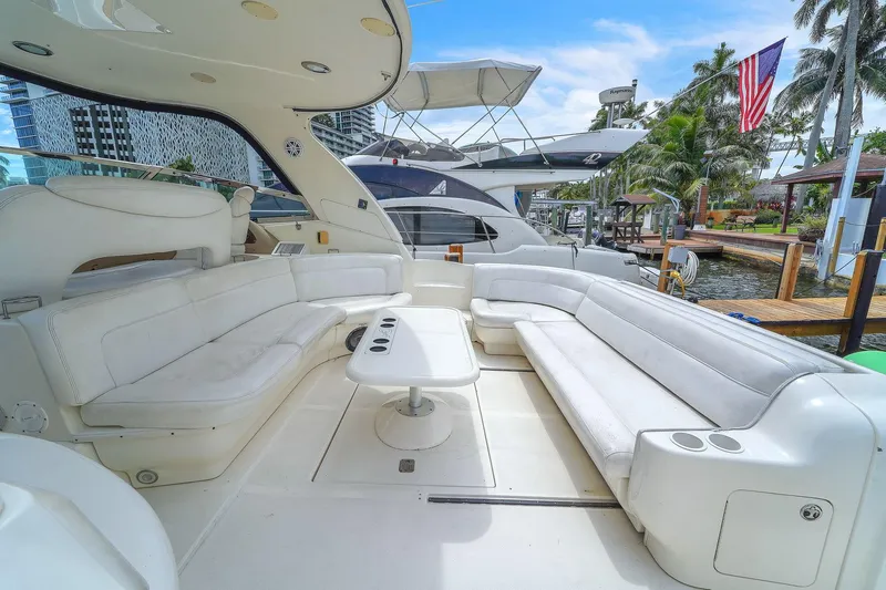  Yacht Photos Pics Luxurious 2004 Sea Ray 460 Sundancer yacht with spacious white seating area and table.