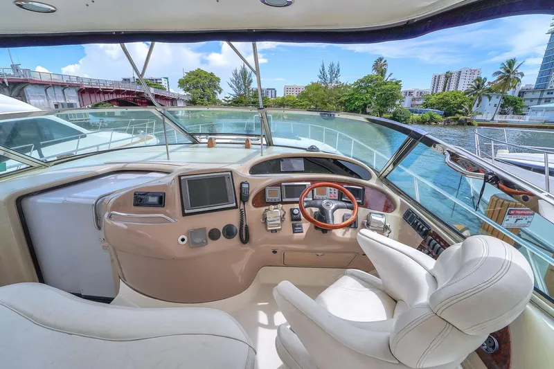  Yacht Photos Pics Helm of 2004 Sea Ray 460 Sundancer yacht with modern controls and scenic waterway view.
