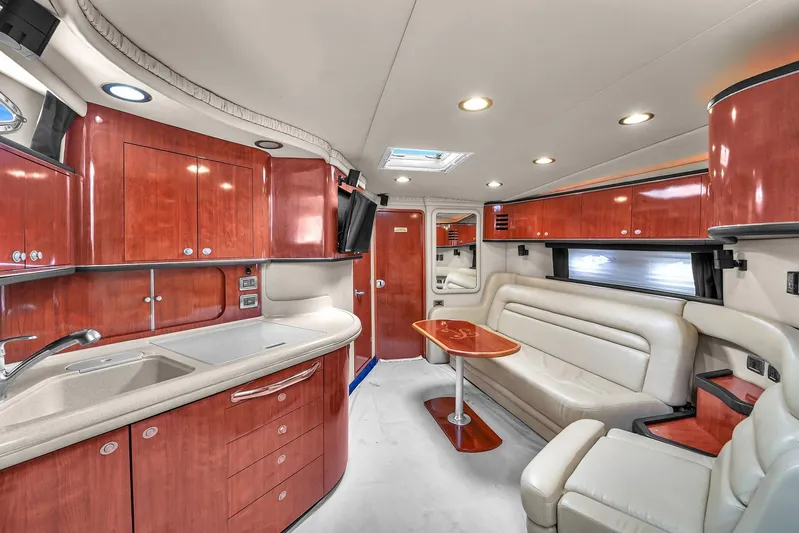 Yacht Photos Pics Luxurious interior of 2004 Sea Ray 460 Sundancer yacht with elegant wood cabinetry and plush seating.