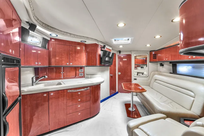  Yacht Photos Pics Luxurious interior of 2004 Sea Ray 460 Sundancer yacht with modern kitchen and seating area.