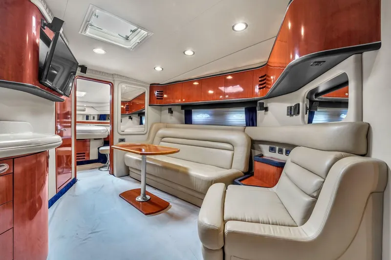  Yacht Photos Pics Luxurious interior of 2004 Sea Ray 460 Sundancer yacht with leather seating and wood accents.
