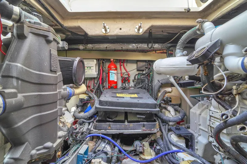  Yacht Photos Pics Engine room of 2004 Sea Ray 460 Sundancer with visible machinery and fire extinguisher.