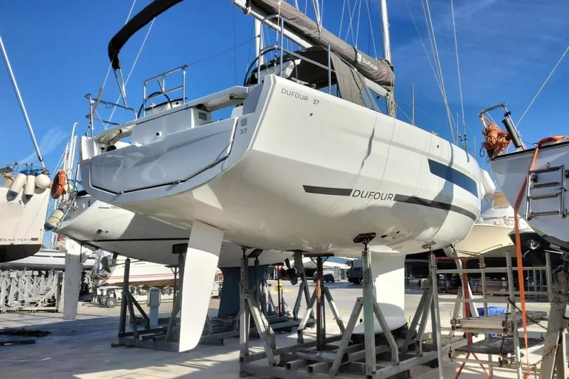  Yacht Photos Pics 2025 Dufour 37 sailboat on dry dock, showcasing sleek design and modern features.