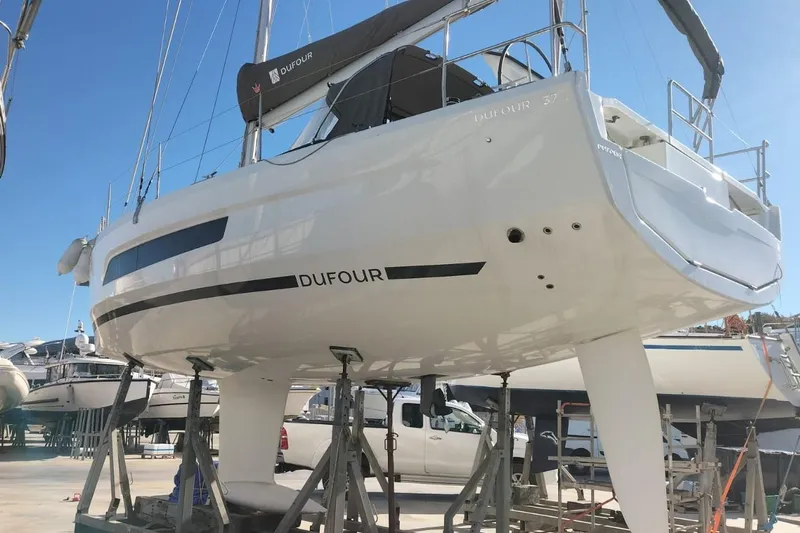  Yacht Photos Pics 2025 Dufour 37 sailboat on dry dock, showcasing sleek design and modern features.