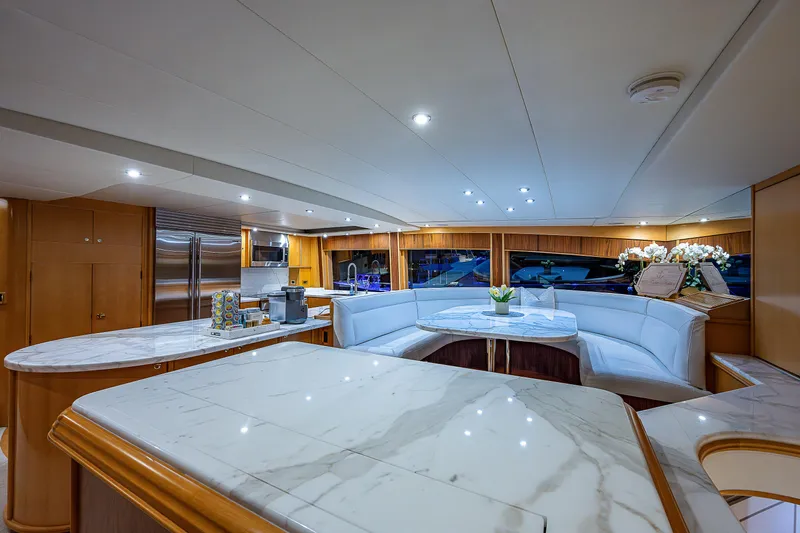 Wire We Here Yacht Photos Pics Luxurious interior of 1995 Crescent Westport Pilothouse yacht with marble countertops and plush seating.