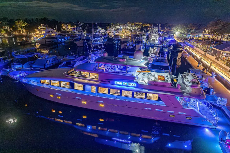 Wire We Here Yacht Photos Pics Crescent Westport Pilothouse 1995 yacht illuminated at night in a marina.