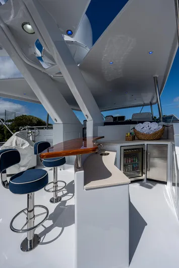 Wire We Here Yacht Photos Pics Luxurious 1995 Crescent Westport Pilothouse yacht with bar stools, mini fridge, and outdoor seating.