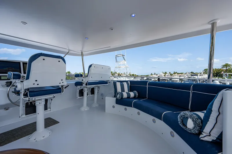 Wire We Here Yacht Photos Pics Luxurious 1995 Crescent Westport Pilothouse yacht interior with blue seating and helm chairs.