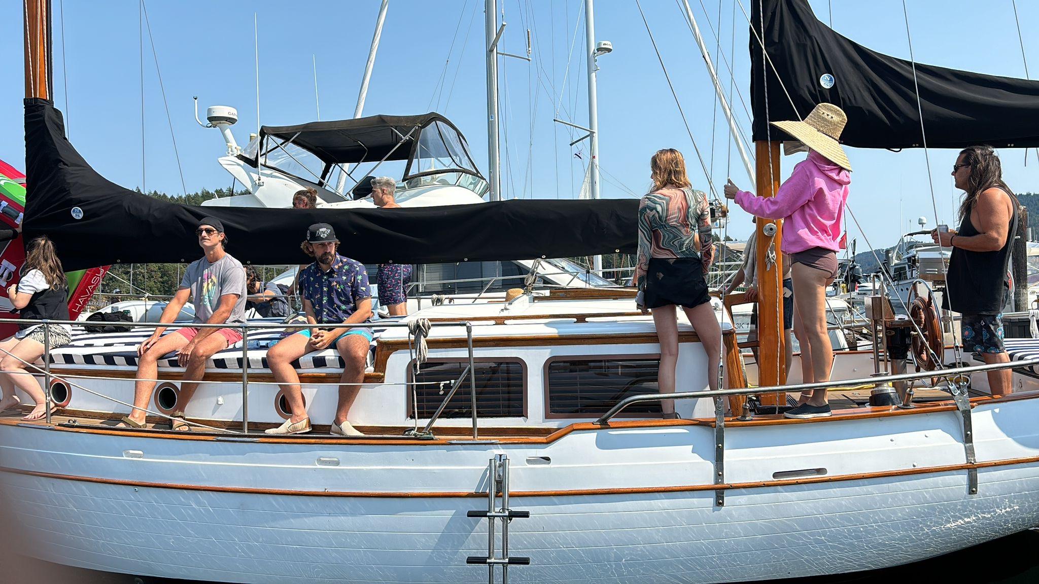 People enjoying a day on a 1976 CT 41 sailboat at a marina.