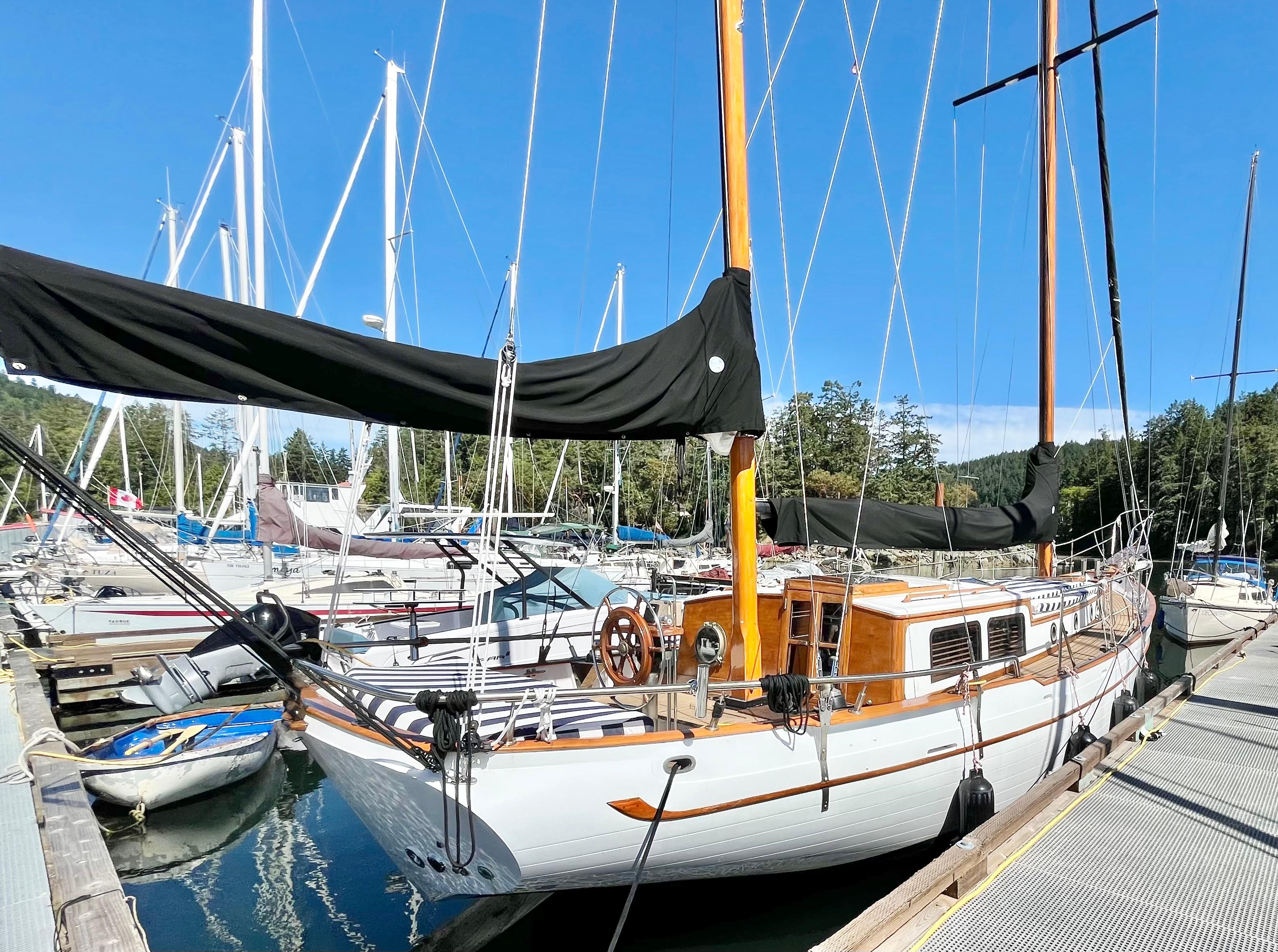 1976 CT 41 sailboat docked at marina, surrounded by other boats under clear blue sky.