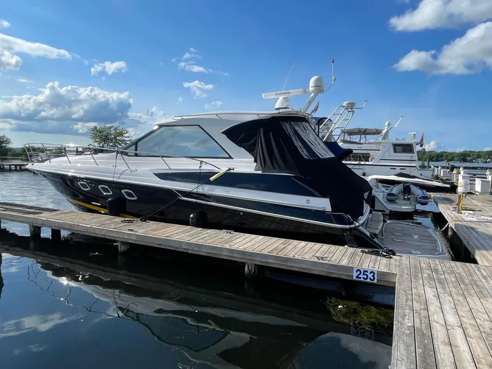  Yacht Photos Pics 2010 Regal 44 Sport Coupe yacht docked at marina under blue sky.