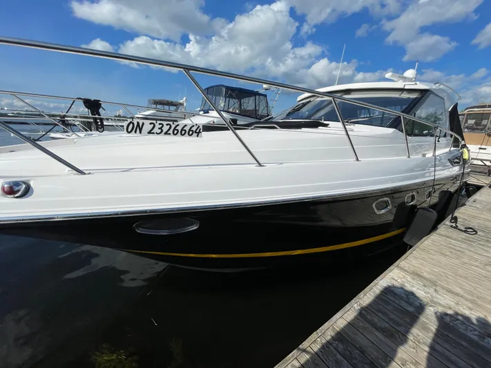  Yacht Photos Pics 2010 Regal 44 Sport Coupe yacht docked under a blue sky.