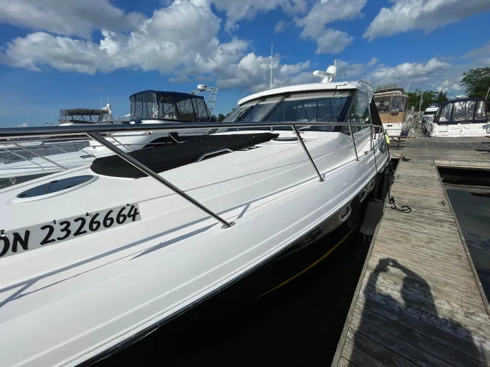  Yacht Photos Pics 2010 Regal 44 Sport Coupe docked at marina under blue sky.