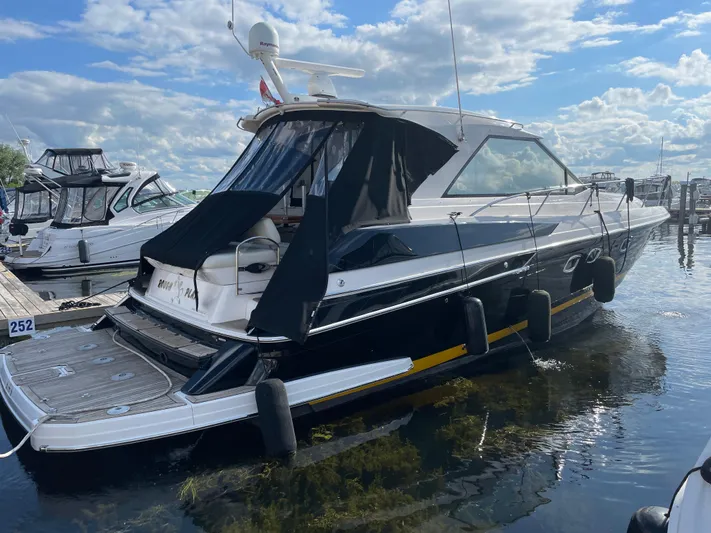  Yacht Photos Pics 2010 Regal 44 Sport Coupe yacht docked at marina under blue sky.
