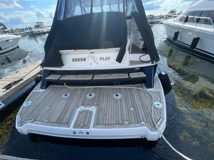  Yacht Photos Pics 2010 Regal 44 Sport Coupe docked, featuring a spacious rear deck and covered seating area.