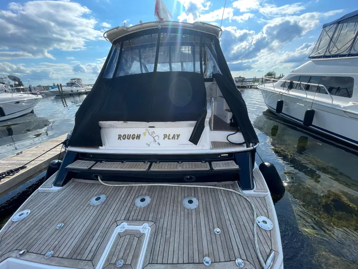 Yacht Photos Pics 2010 Regal 44 Sport Coupe yacht docked, rear view with "Rough Play" text, sunny day.