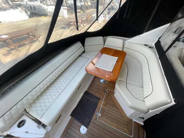  Yacht Photos Pics Luxurious seating area on a 2010 Regal 44 Sport Coupe yacht with wooden table.