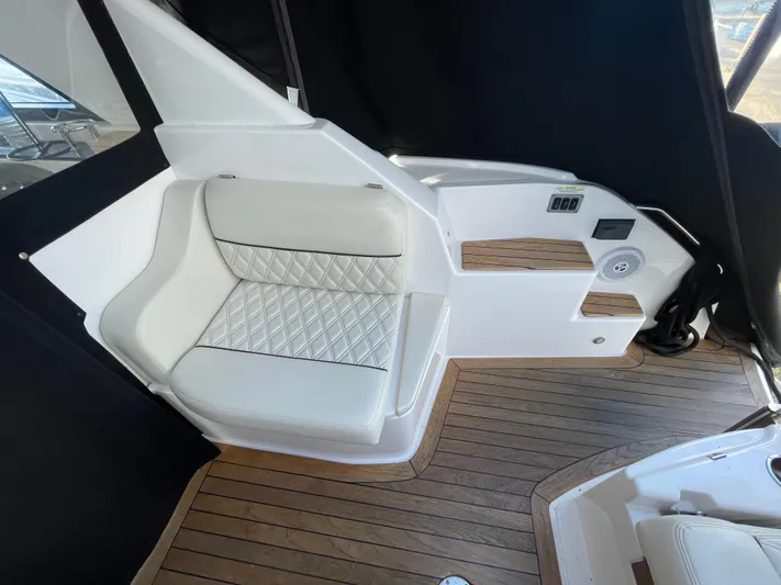  Yacht Photos Pics Luxurious interior of 2010 Regal 44 Sport Coupe with white seating and wood flooring.