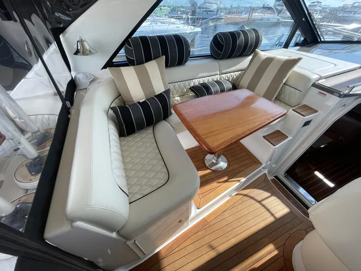  Yacht Photos Pics Luxurious interior of 2010 Regal 44 Sport Coupe with elegant seating and wooden table.