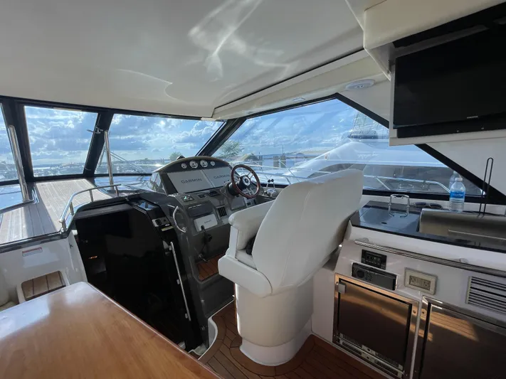  Yacht Photos Pics Interior of 2010 Regal 44 Sport Coupe yacht with helm, seating, and navigation equipment.