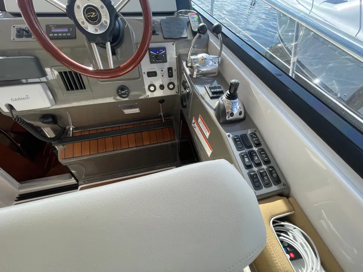  Yacht Photos Pics 2010 Regal 44 Sport Coupe helm with controls, steering wheel, and navigation equipment.