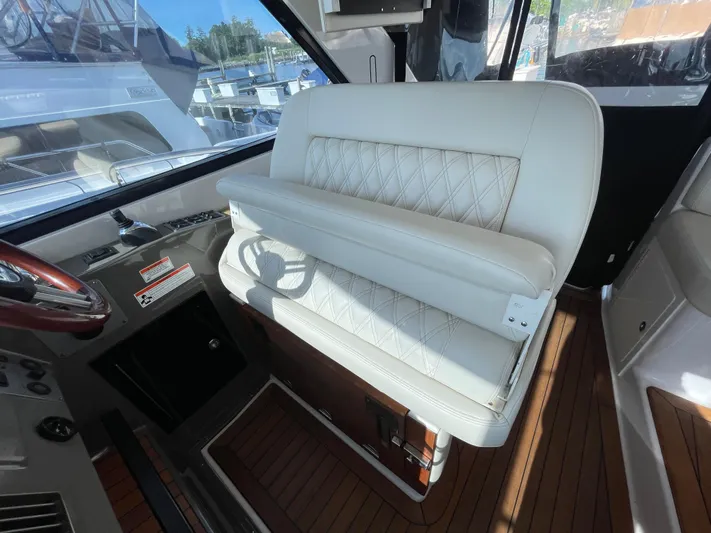  Yacht Photos Pics Luxurious interior of 2010 Regal 44 Sport Coupe with white leather seating and wood accents.