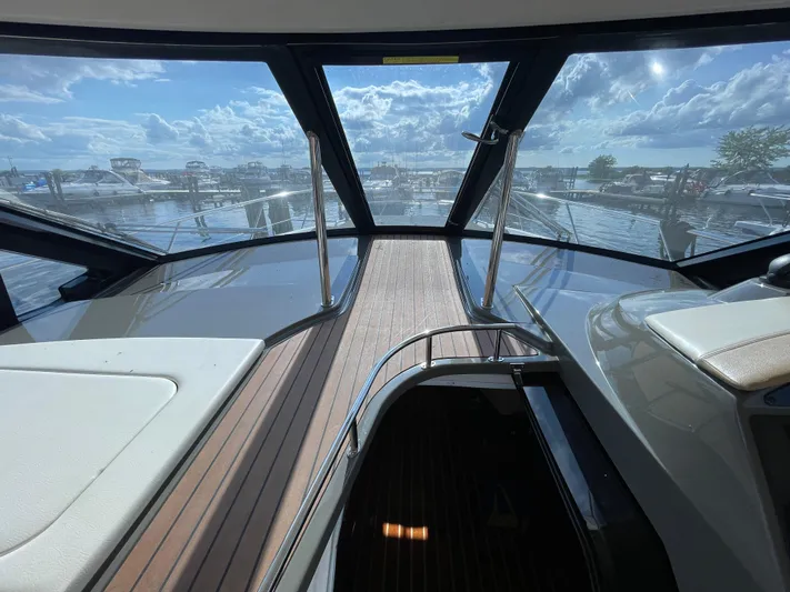  Yacht Photos Pics 2010 Regal 44 Sport Coupe interior with panoramic marina view through large windows.
