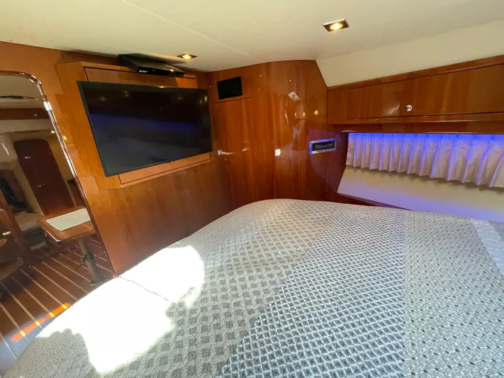  Yacht Photos Pics Luxurious interior of 2010 Regal 44 Sport Coupe with TV and wood paneling.