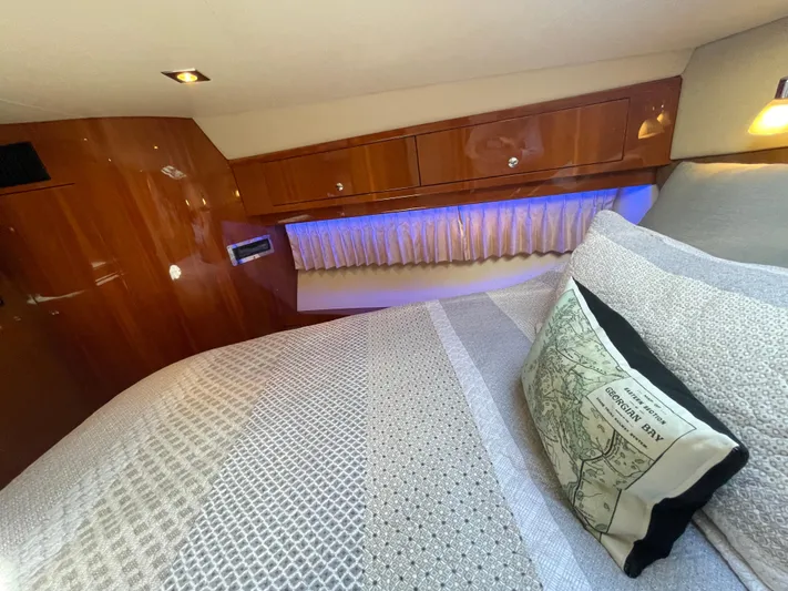  Yacht Photos Pics Luxurious cabin interior of 2010 Regal 44 Sport Coupe with elegant bedding and wood finish.