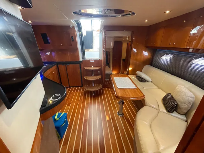  Yacht Photos Pics Luxurious interior of 2010 Regal 44 Sport Coupe yacht with elegant wood finishes.