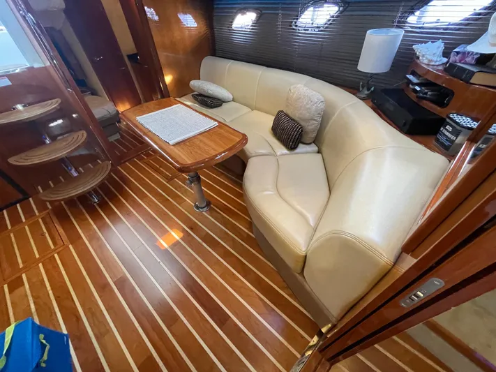  Yacht Photos Pics Luxurious interior of 2010 Regal 44 Sport Coupe with leather seating and wooden flooring.